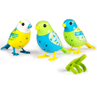 A set of three blue, yellow, and green DigiBirds next to a green whistle.