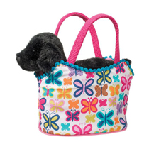 A black lab in a colorful purse with butterflies on it.