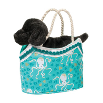 A puppy in a teal bag with happy octopus on it.