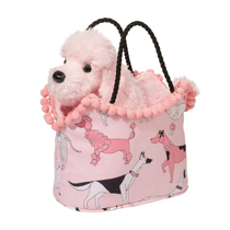 A pink poodle in a cute hand bag.