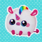 A round cream and rainbow colored unicorn plush.