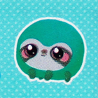A round green sloth plush.