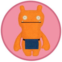 An orange monster wearing a blue apron.